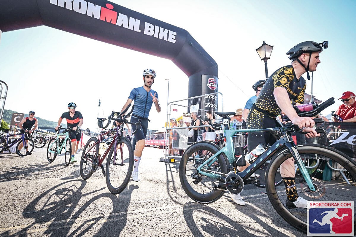 Exiting transition 1 (swim to bike) with my bike for a 90km ride.